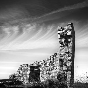 A ruined tower under swirling clouds