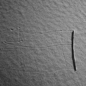 Marks left on the sand by a rolling straw