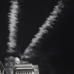 V-shaped cloud above building with domed tower in Vichy, France