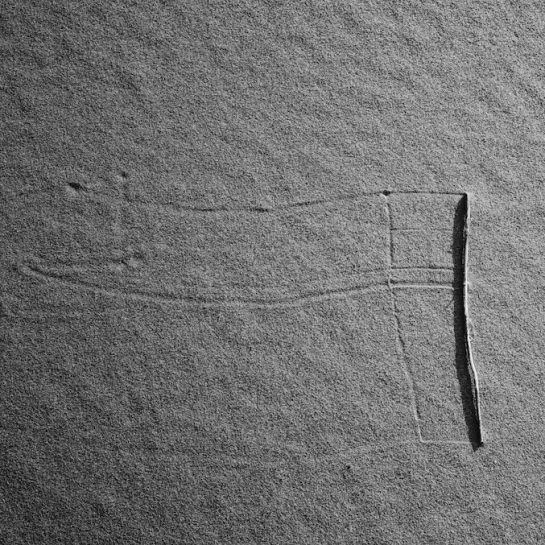 Marks left on the sand by a rolling straw